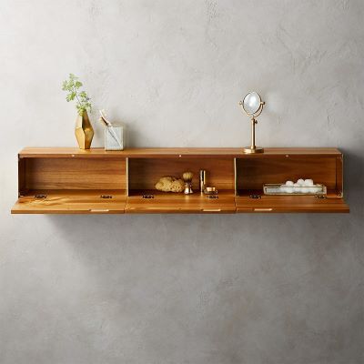a wooden storage floating shelf that contains toiletries